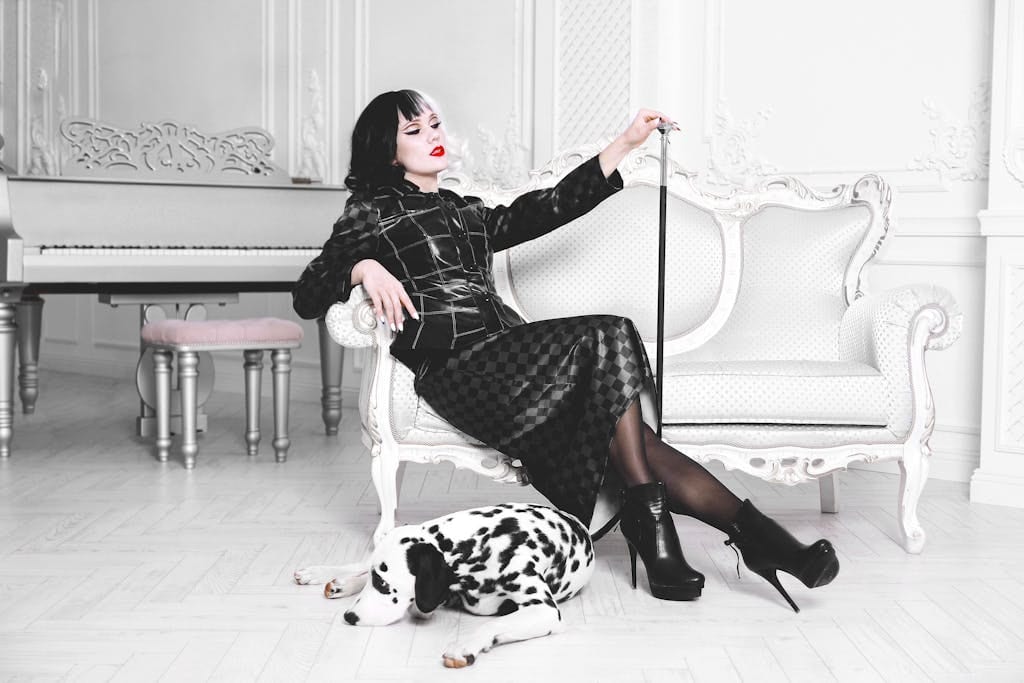 Chic woman in fashion attire with Dalmatian dog in vintage interior setting, exuding elegance.
